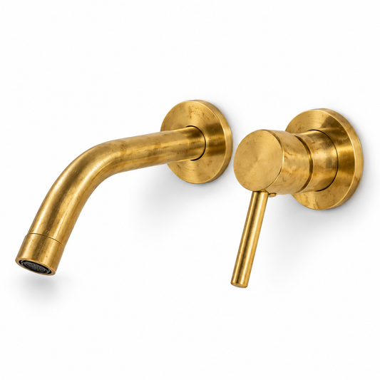 Unlacquered brass wall-mount sink faucet with an angled spout and single lever handle on a white background