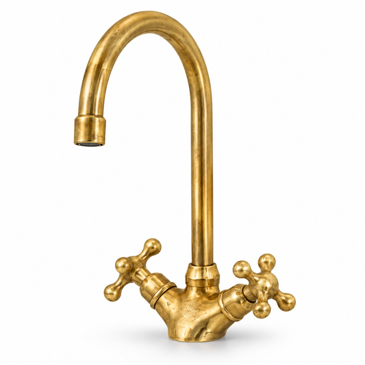 Wenston unlacquered brass single-hole faucet with tall curved spout and cross handles on white background