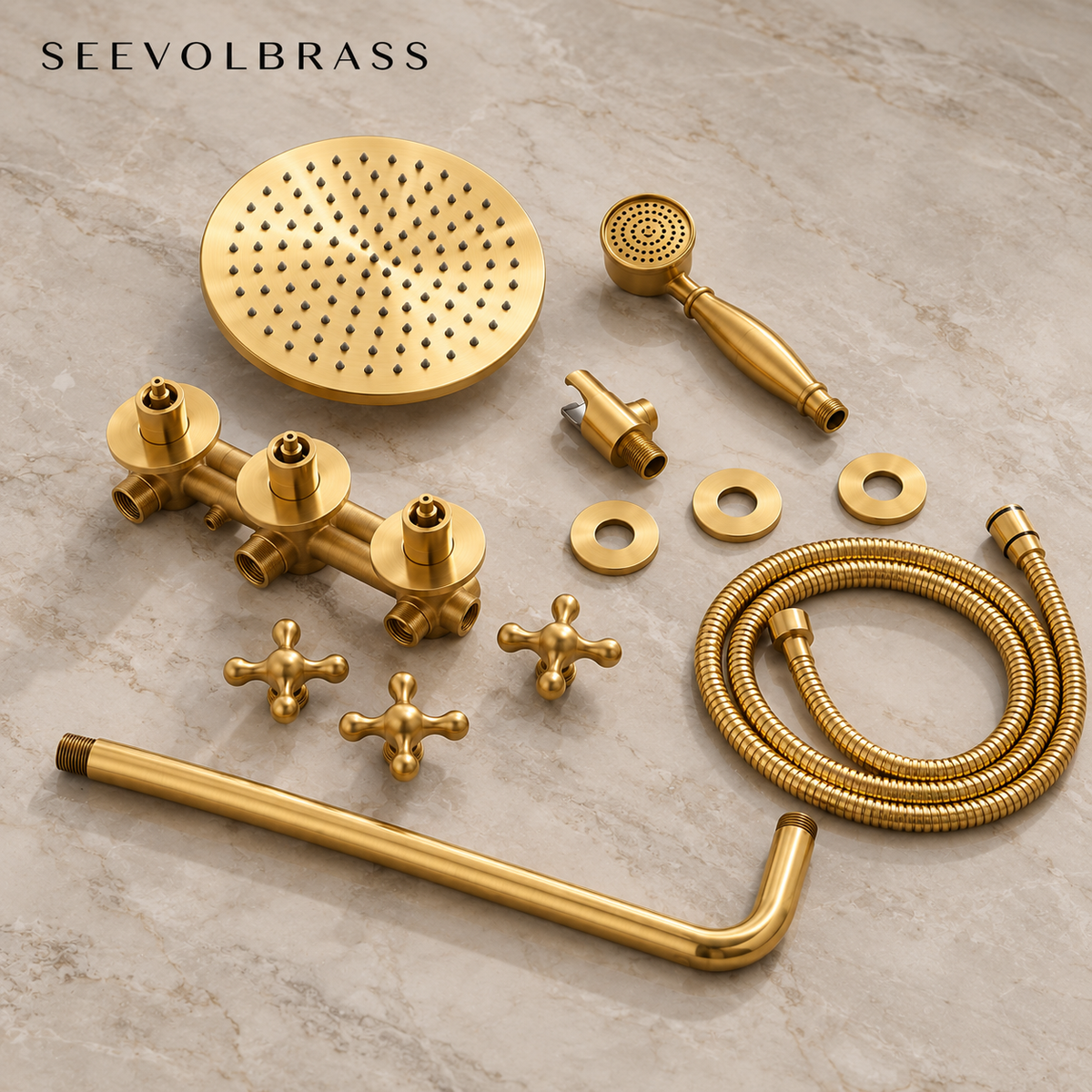 Eden unlacquered brass shower components laid out on stone, including valve, cross handles, rainfall head, hand shower and hose