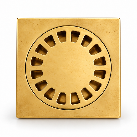 A square brass floor drain with a circular slotted cover, shown from a top-down perspective on a white background.