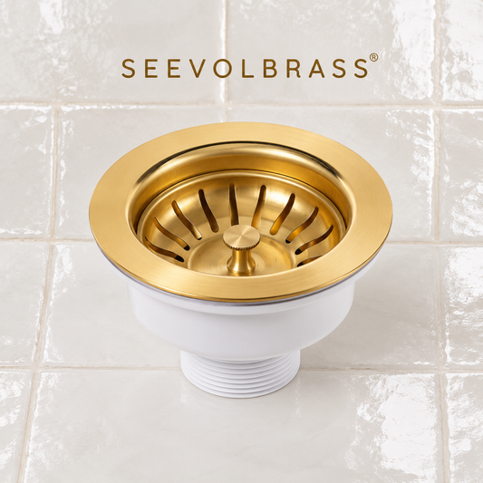 Angled view of the unlacquered brass sink strainer with slotted basket, stopper knob and white threaded drain body