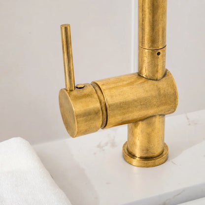 Close-up of the Brewster faucet’s unlacquered brass single lever and cylindrical base