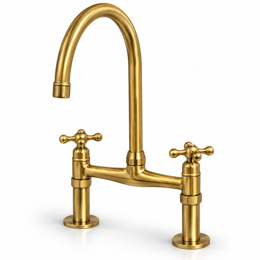 Angled view of unlacquered brass bridge kitchen faucet with cross handles and a high-arc spout on a white background