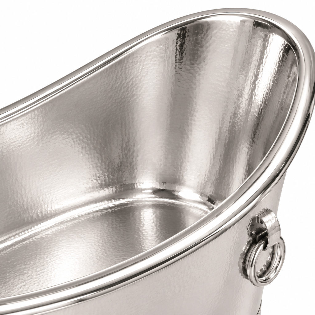Close-up of a polished silver metal bucket with a hammered finish and a metal ring handle on a white background.